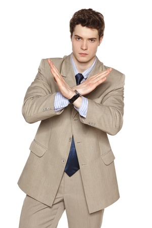 Young business man making stop gesture against white backgroundの写真素材
