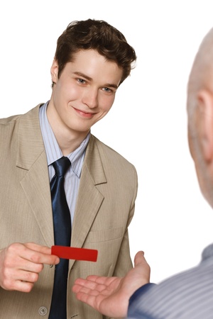 Young business man smiling while giving his credit cardの写真素材