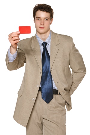 Young business man giving you a blank credit card looking at you with serious lookの写真素材