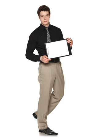 Young serious businessman showing blank clipboard, over white backgroundの写真素材