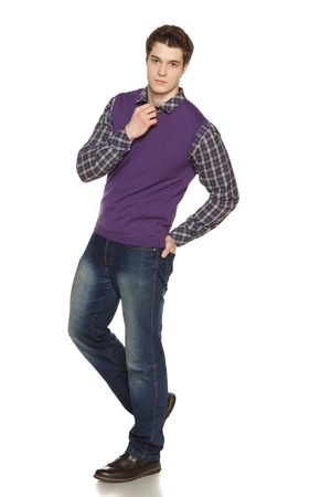 Full length studio portrait of a stylishly-dressed young man smiling at the camera over white backgroundの写真素材