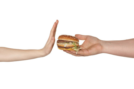 Female hand refusing the fast food mealの写真素材