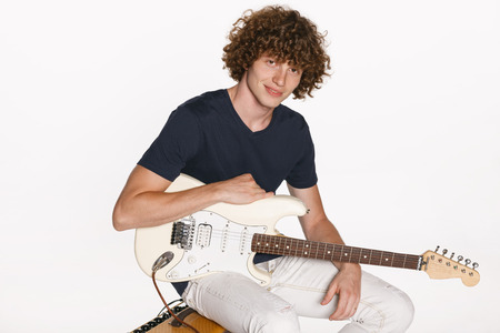 Redheade male musician with his guitar over white backgroundの写真素材