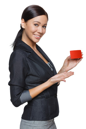Smiling business woman holding credit card isolated on white backgroundの写真素材