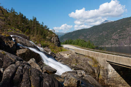 Detail of lovely waterfall Langfoss and a road, Norwayの写真素材