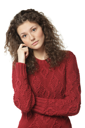Young beautiful female in sweater with folded hands, isolated on white backgroundの写真素材