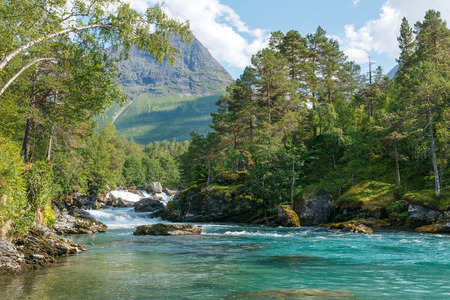 Mountain river passing in green Norwegian mountainsの写真素材