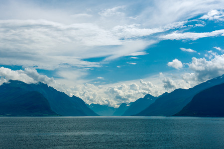 Norway  Fjord scene with hazy mountains and cloudy sky in a overcast dayの写真素材