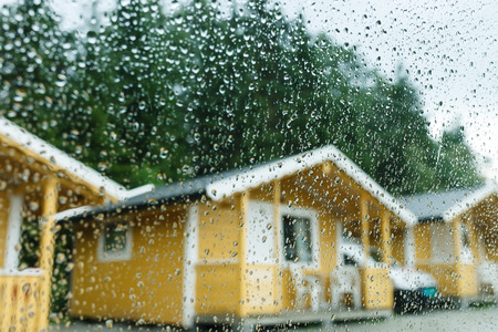 Camping cabins in heavy rain - view through the windowの写真素材