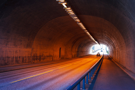Urban highway road tunnel lighted with colorful lightsの写真素材