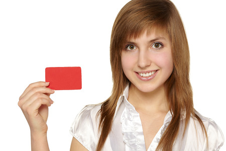 Beautiful smiling girl showing red card in hand, over white backgroundの写真素材