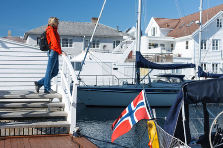 Woman enjoying view at Skudeneshavn village in Norwayの写真素材