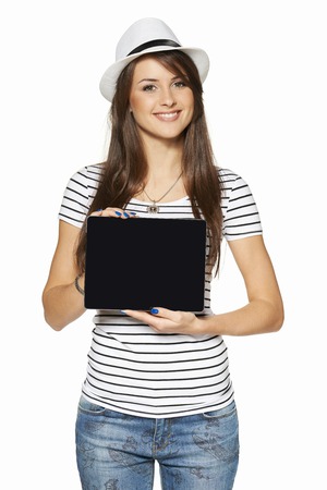 Woman showing tablet computer screen smiling wearing straw hat isolated on white .の写真素材