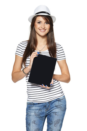 Woman showing tablet computer screen smiling wearing straw hat isolated on white .の写真素材