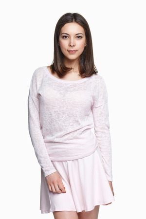 Portrait of a lovely woman in romantic clothing: light pink skirt and pulloverの写真素材
