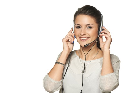 Headset woman call center operator smiling, against white の写真素材