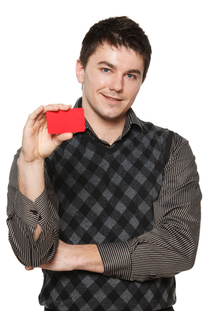 Smiling confident man showing red card in hand, over white backgroundの写真素材