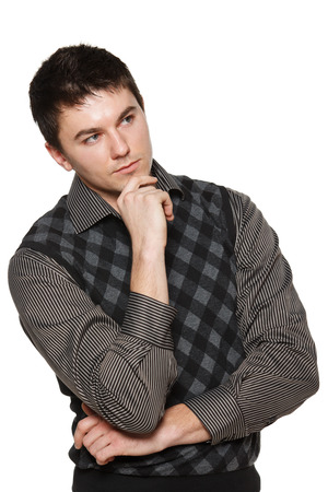 Man standing with halded hands and thinking about something, looking awayの写真素材