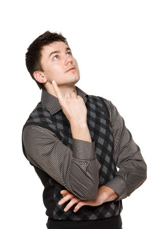 Surprised young man looking up in shock and pointing, over white の写真素材
