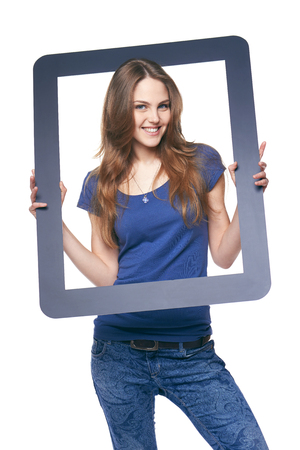 Smiling woman holding tablet frame, over white backgroundの写真素材