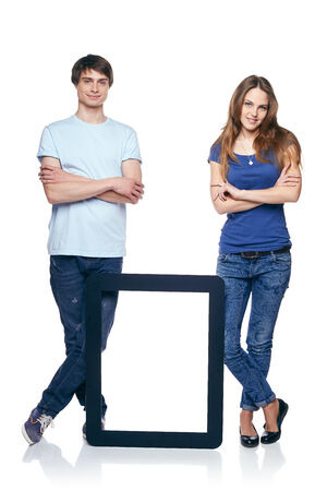 Full length couple standing with tablet frame, over white backgroundの写真素材