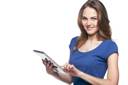 Tablet computer. Woman using digital tablet isolated on white background.の写真素材