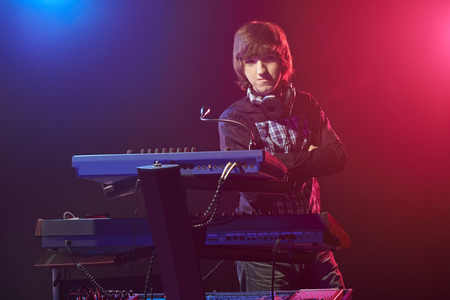 Musician sitting on a keyboard before a concertの写真素材