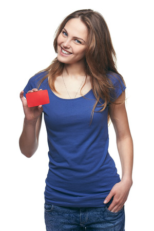 Happy smiling girl in casual clothing, showing blank credit card, on white backgroundの写真素材