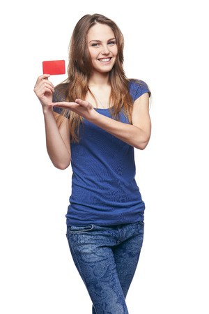 Happy smiling girl in casual clothing, showing blank credit card, on white backgroundの写真素材
