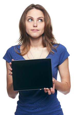 Woman showing tablet screen looking up at copy space, isolated on white backgroundの写真素材