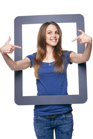Smiling woman holding tablet frame, over white backgroundの写真素材