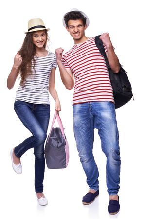 Full length of expressive young couple of tourists gesturing screaming of joy, over white backgroundの写真素材