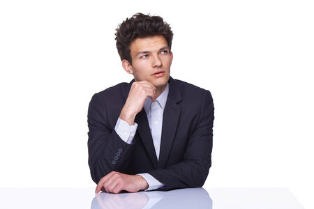 Thoughtful handsome business man sitting looking to the sideの写真素材