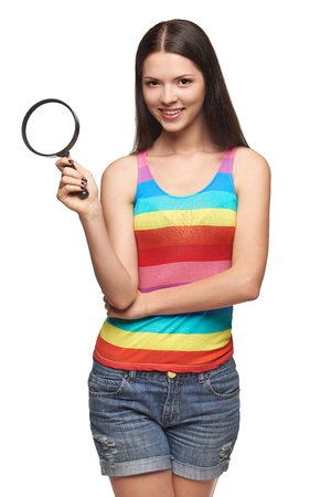 Woman with magnifying glass over white backgroundの写真素材