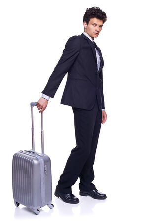 Full length of a businessman walking with a luggage, over white backgroundの写真素材