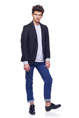 Full body of a fashion man with modern haircut posing over white の写真素材