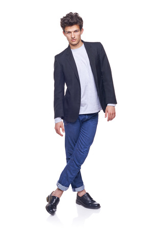 Full body of a fashion man with modern haircut posing over white backgroundの写真素材