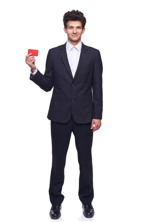 Full body elegant smiling business man showing blank credit card, over white background.の写真素材