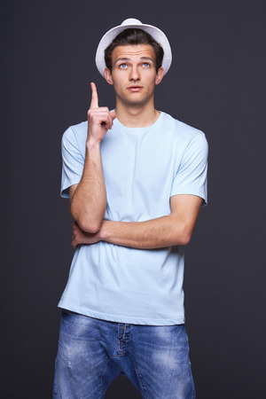 Funny image of surprised man pointing upの写真素材