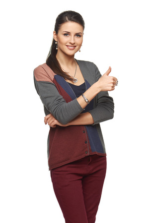 Gorgeous young brunette showing big thumbs up on white background.の写真素材