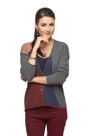 Portrait of lovely smiling young girl in cardigan looking at camera, over white backgroundの写真素材