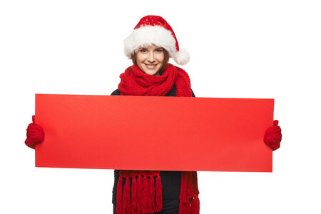Christmas, X-mas, Xmas sale, shopping concept - Smiling woman wearing Santa hat with red sale sign - empty copy space for your text, looking at cameraの写真素材