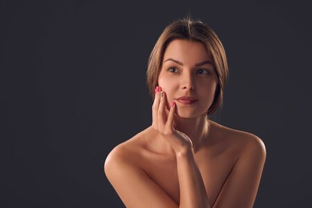 Closeup woman portrait over gray studio background