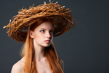 Closeup of beautiful woman in natural wreath of wicker, studio portait with copy spaceの写真素材