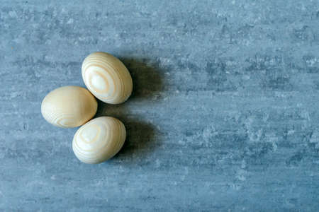 Top view of wooden eggs on grey concrete backgroundの写真素材
