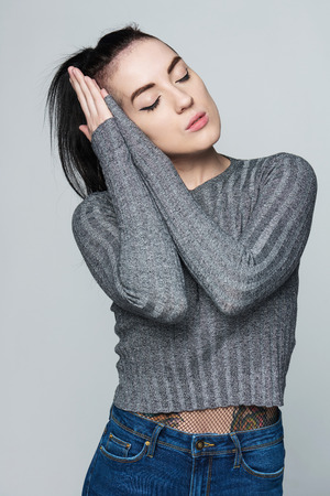 Funky woman resting with eyes closed, isolated portraitの写真素材