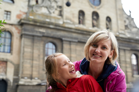 Happy family laughing in downtown old city Europeの写真素材