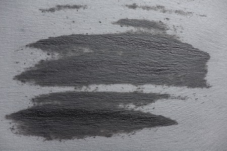 Top view of gray slate surface with wet marks strokes