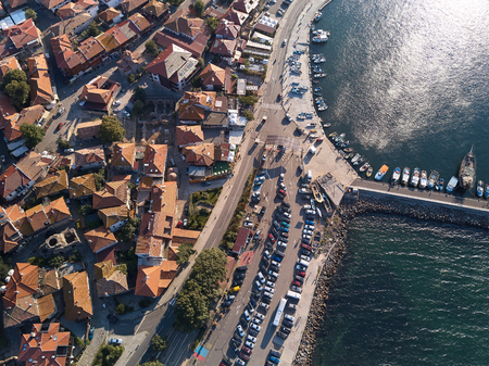 Top view Aerial view of the tile roofs of old Nessebar, parking place and marine, ancient city on...