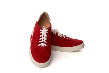 Red casual suede shoes , Studio shot over white backgroundの写真素材